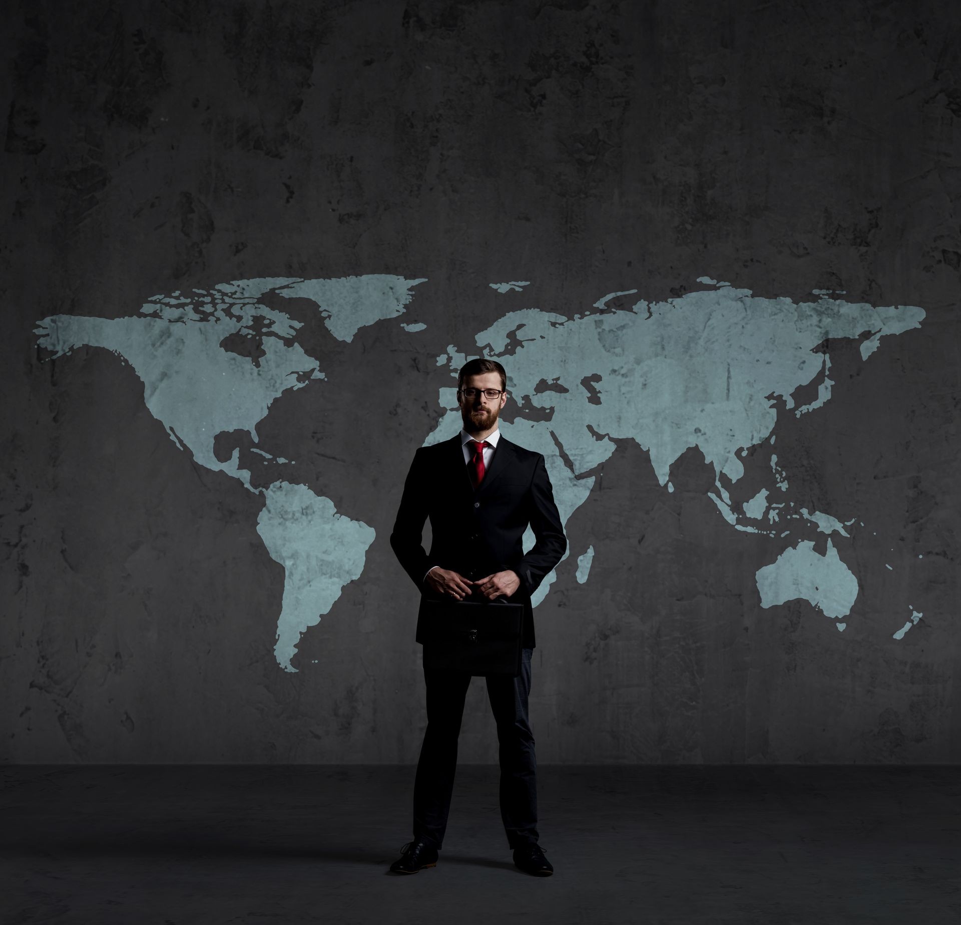 Businessman standing  with briefcase. World map background. Business, globalization, concept.